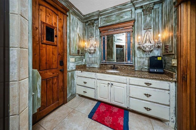 bathroom with vanity, crown molding, and tile patterned floors