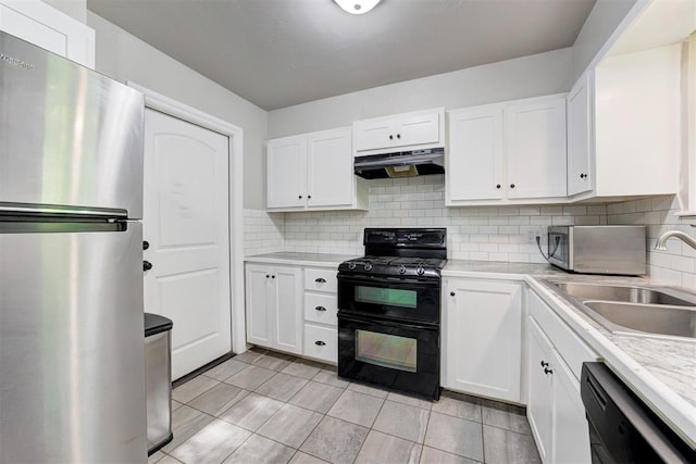 700 Redwood Dr, Noble, OK 73068 - kitchen featuring black appliances, extractor fan, light countertops, and white cabinetry