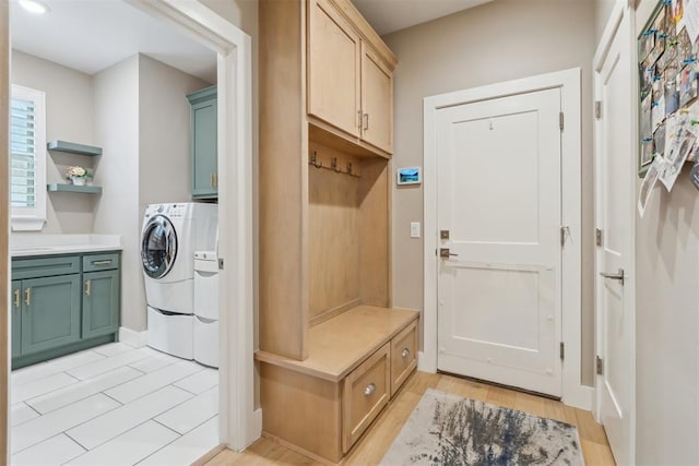 mudroom featuring washing machine and dryer and light wood finished floors
