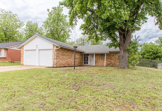 single story home featuring a front yard, brick siding, an attached garage, and fence