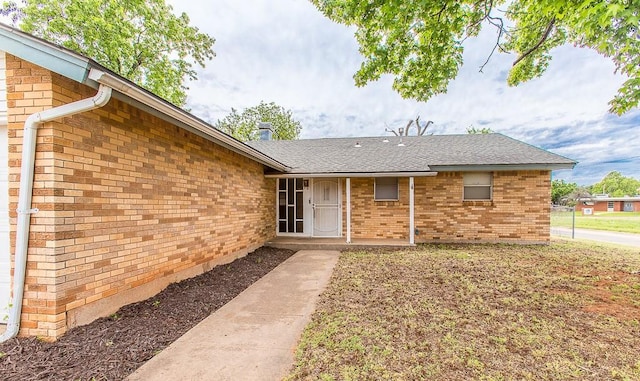 property entrance with brick siding