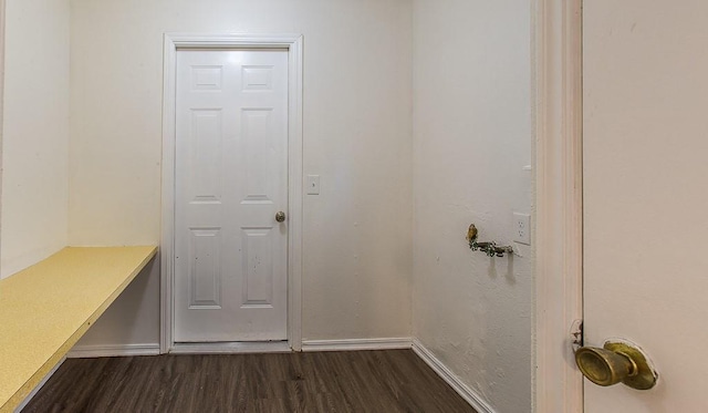 mudroom featuring baseboards and dark wood-type flooring