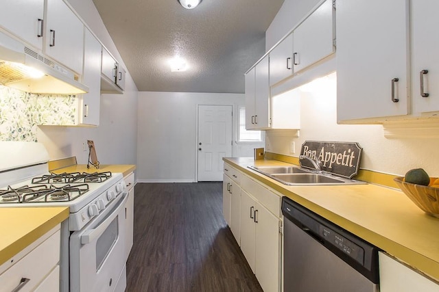 kitchen with light countertops, a sink, gas range gas stove, dishwasher, and dark wood-style floors