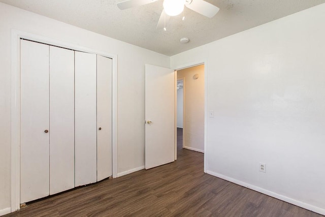 unfurnished bedroom with baseboards, a closet, a ceiling fan, and wood finished floors