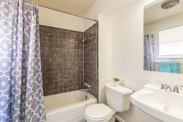 full bathroom featuring toilet, shower / tub combo, and a sink