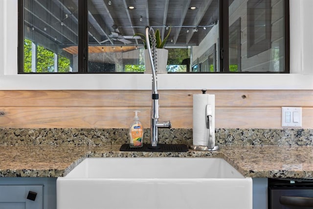 details with a sink, stone counters, decorative backsplash, and dishwasher