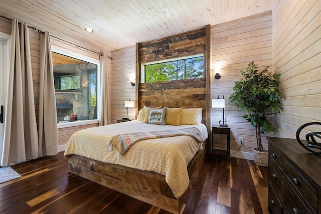 bedroom featuring wooden ceiling, wooden walls, and dark wood-type flooring