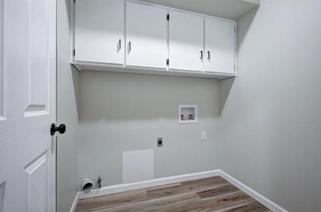 laundry room with cabinet space, wood finished floors, electric dryer hookup, washer hookup, and baseboards