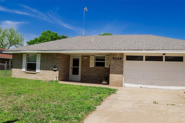 1046 W Sunset Cir, Yale, OK 74085 - single story home featuring driveway, brick siding, roof with shingles, and a front lawn