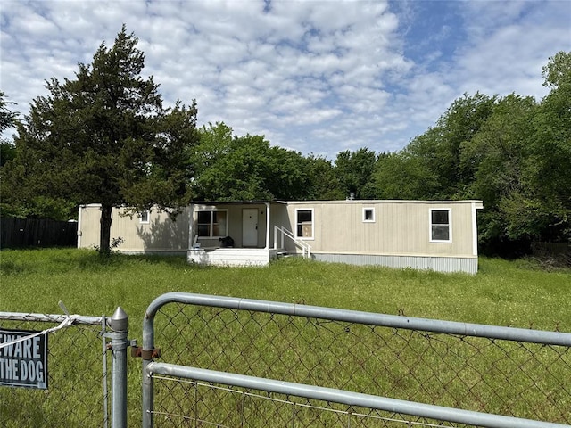rear view of property featuring covered porch and fence private yard