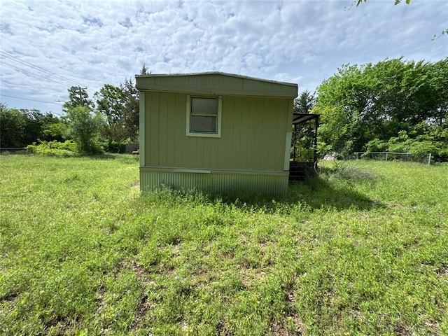 view of outbuilding featuring fence