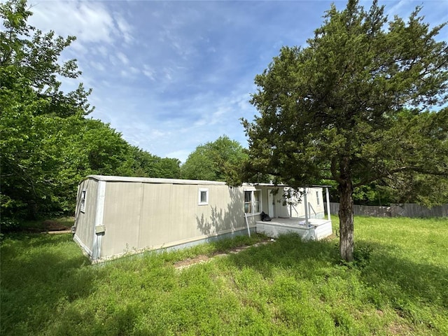 exterior space featuring a lawn and fence