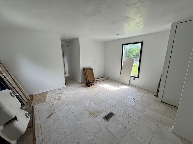 unfurnished room with light tile patterned floors