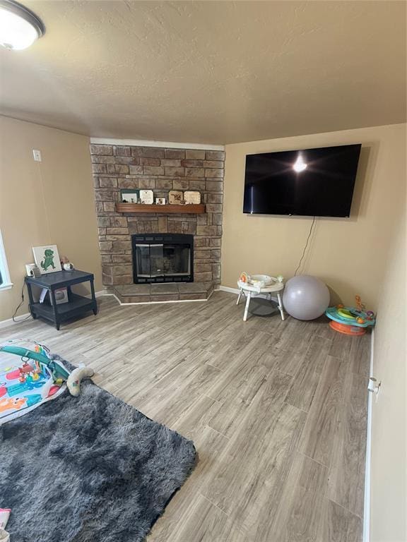 30738 NW Reno Rd, Hinton, OK 73047 - living room with baseboards, a stone fireplace, and wood finished floors