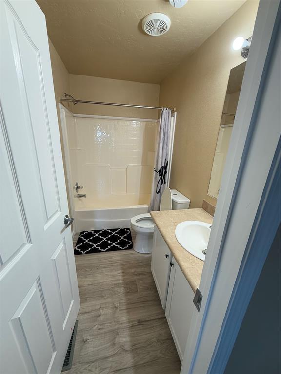 30738 NW Reno Rd, Hinton, OK 73047 - bathroom featuring vanity, toilet, visible vents, and wood finished floors