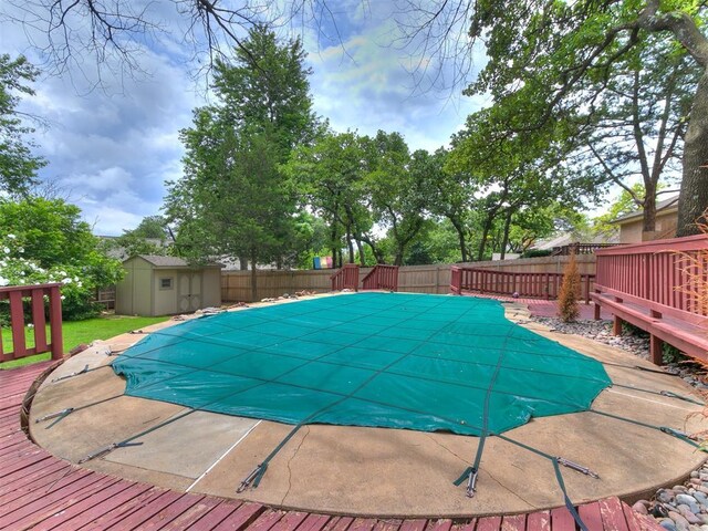 904 Carfax Rd, Edmond, OK 73034 - view of pool featuring a fenced backyard, a wooden deck, and a storage shed
