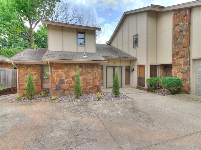 904 Carfax Rd, Edmond, OK 73034 - view of front facade with stone siding and a shingled roof
