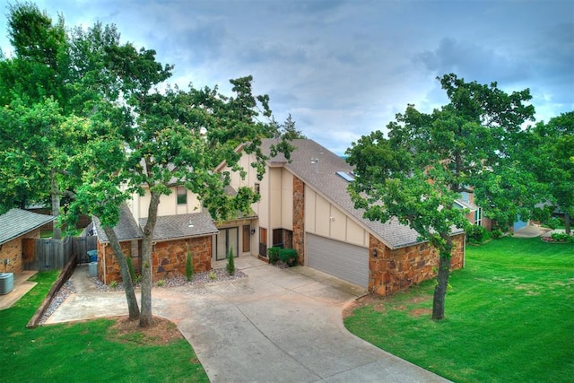 904 Carfax Rd, Edmond, OK 73034 - view of front of home with stone siding, concrete driveway, an attached garage, and board and batten siding