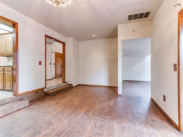 904 Carfax Rd, Edmond, OK 73034 - empty room with light wood-style flooring and baseboards