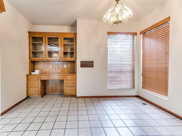 904 Carfax Rd, Edmond, OK 73034 - unfurnished office with a chandelier, healthy amount of natural light, and light tile patterned floors