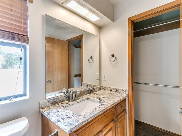 904 Carfax Rd, Edmond, OK 73034 - bathroom with vanity and wood finished floors