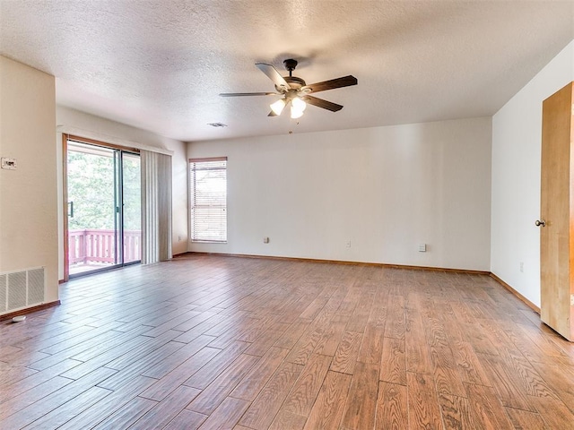 904 Carfax Rd, Edmond, OK 73034 - spare room featuring light wood-style floors, ceiling fan, and a textured ceiling
