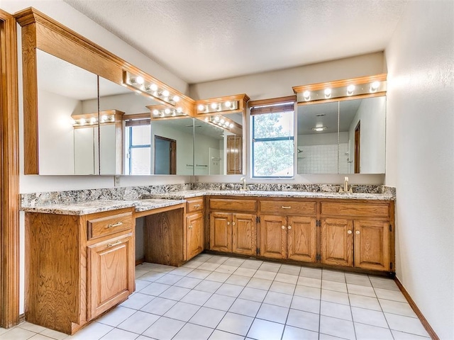 904 Carfax Rd, Edmond, OK 73034 - bathroom featuring plenty of natural light, double vanity, and tile patterned floors