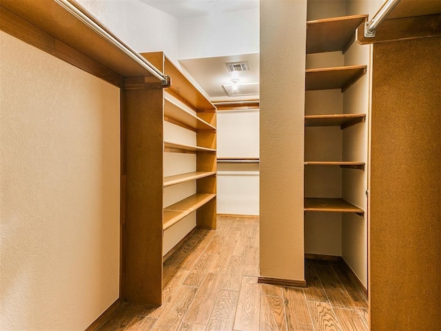 904 Carfax Rd, Edmond, OK 73034 - walk in closet with wood finished floors