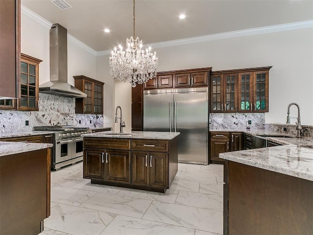 6209 Lakewood Ridge Rd, Edmond, OK 73013 - kitchen with high end appliances, range hood, light marble finish floors, light stone countertops, and ornamental molding