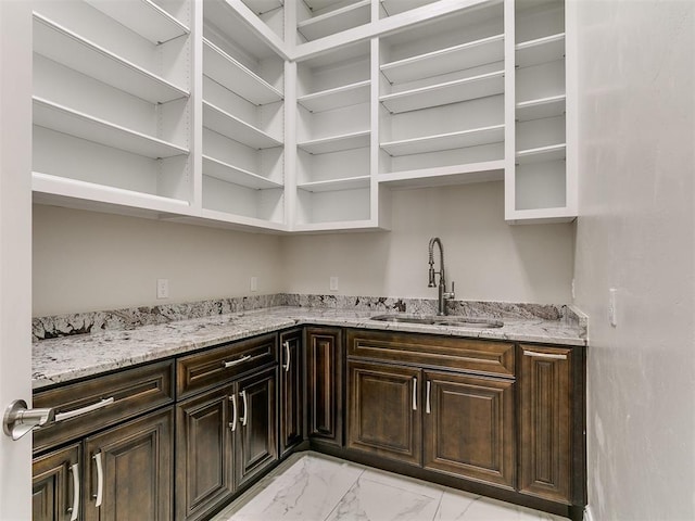 6209 Lakewood Ridge Rd, Edmond, OK 73013 - kitchen featuring open shelves, light marble finish flooring, light stone counters, and dark brown cabinetry