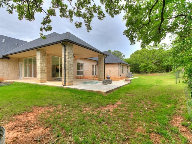 6209 Lakewood Ridge Rd, Edmond, OK 73013 - rear view of house with a patio, a lawn, stone siding, and brick siding