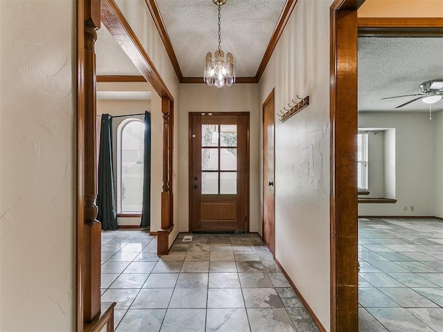 908 Carfax Rd, Edmond, OK 73034 - foyer with a textured ceiling, a chandelier, ceiling fan, and crown molding