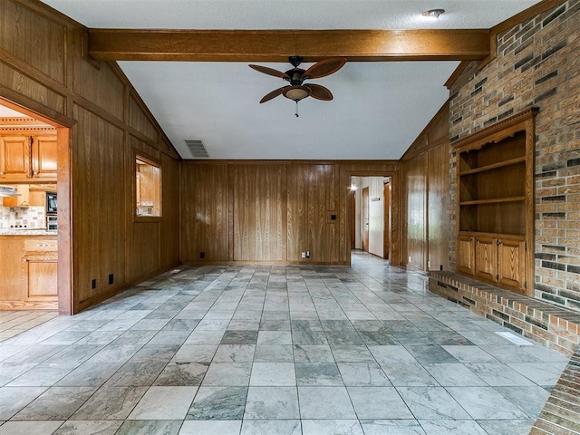 908 Carfax Rd, Edmond, OK 73034 - unfurnished living room with a ceiling fan and wood walls