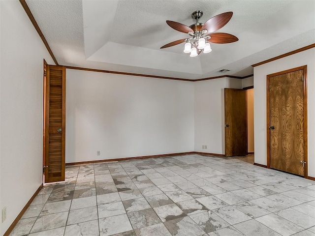 908 Carfax Rd, Edmond, OK 73034 - unfurnished room with ceiling fan, a textured ceiling, a raised ceiling, crown molding, and light marble finish floors