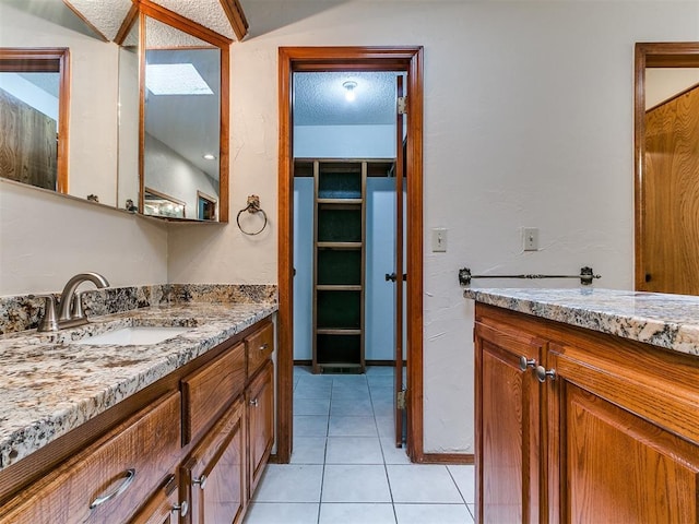 908 Carfax Rd, Edmond, OK 73034 - full bath featuring vanity, tile patterned flooring, and a textured ceiling