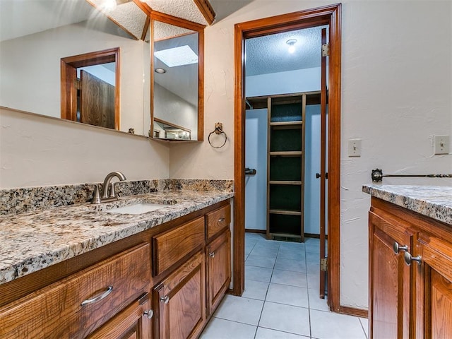 908 Carfax Rd, Edmond, OK 73034 - bathroom with vanity, tile patterned flooring, and a textured ceiling