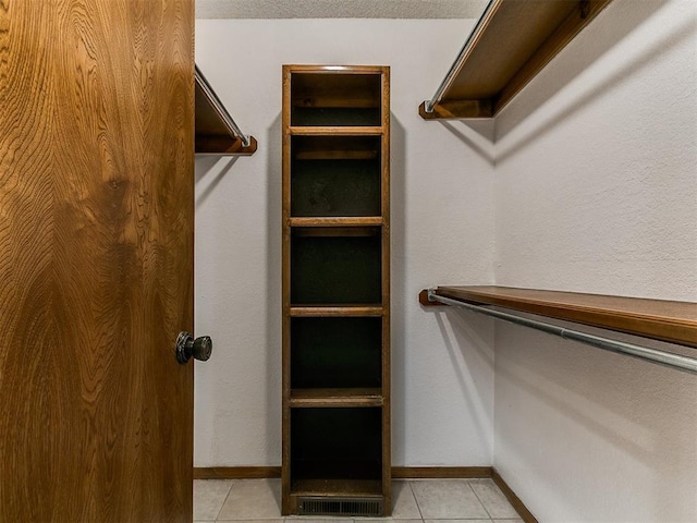 908 Carfax Rd, Edmond, OK 73034 - spacious closet featuring light tile patterned flooring