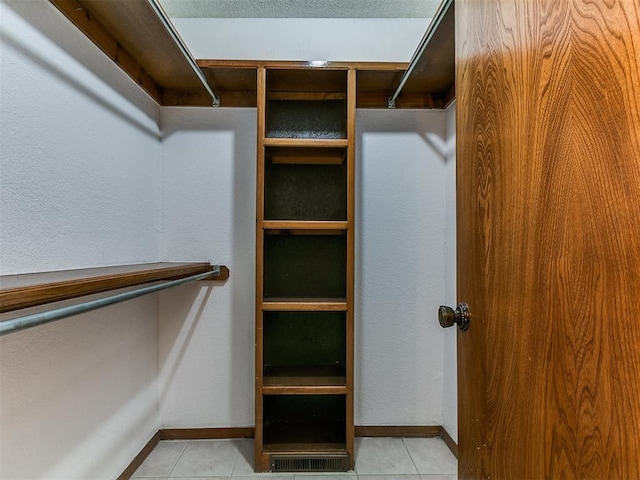 908 Carfax Rd, Edmond, OK 73034 - walk in closet with light tile patterned floors