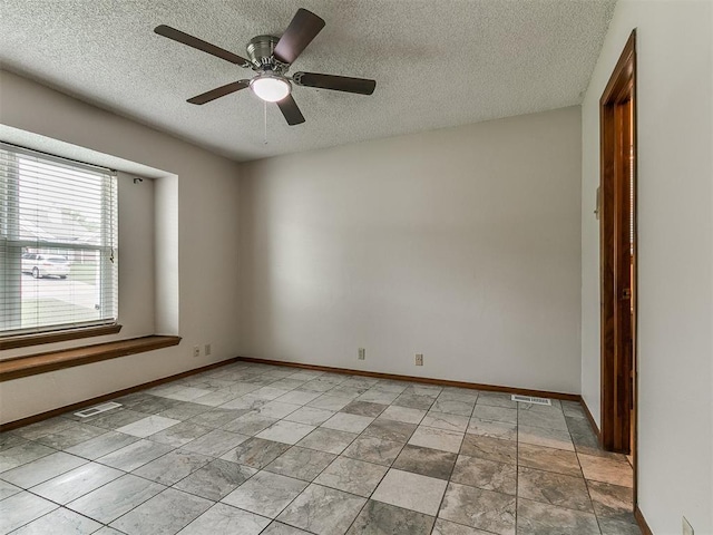 908 Carfax Rd, Edmond, OK 73034 - spare room featuring a textured ceiling and ceiling fan