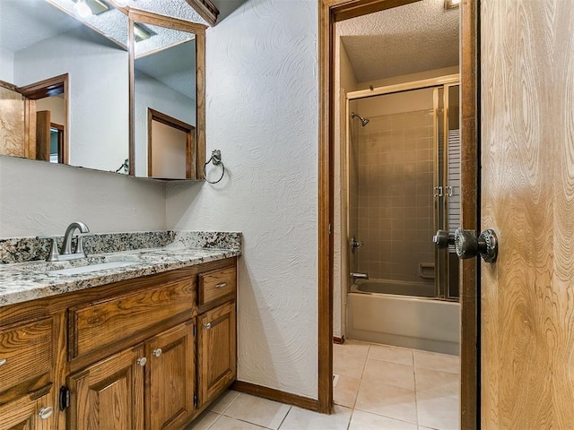908 Carfax Rd, Edmond, OK 73034 - full bath with vanity, enclosed tub / shower combo, tile patterned floors, a textured wall, and a textured ceiling