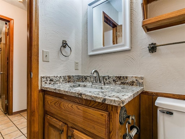 908 Carfax Rd, Edmond, OK 73034 - half bath with vanity, tile patterned floors, and wainscoting