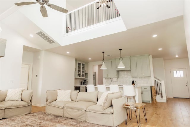 7310 S Brookwater Way, Stillwater, OK 74074 - living room with light wood-type flooring, recessed lighting, visible vents, and high vaulted ceiling