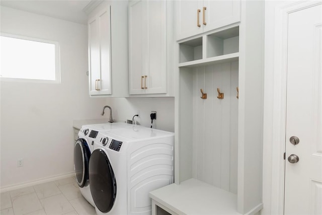 7310 S Brookwater Way, Stillwater, OK 74074 - clothes washing area featuring baseboards, marble finish floor, washer and dryer, and cabinet space