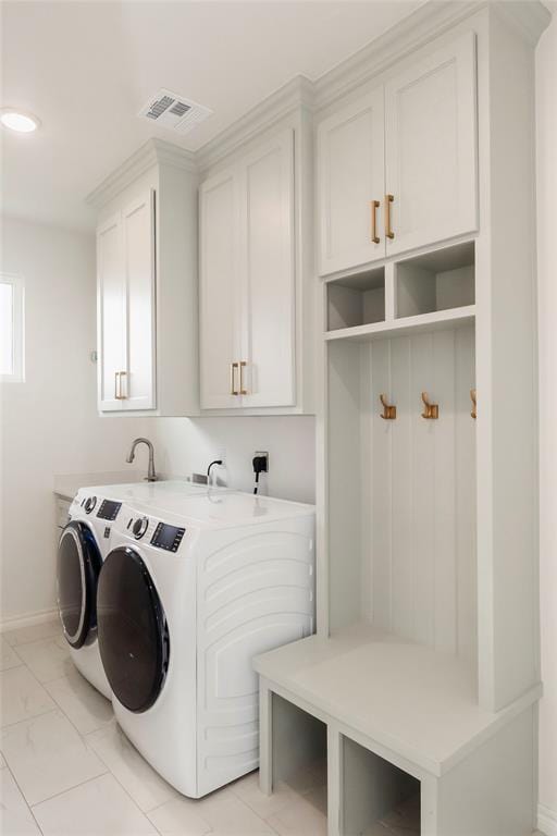 7310 S Brookwater Way, Stillwater, OK 74074 - laundry area featuring cabinet space, marble finish floor, visible vents, washing machine and clothes dryer, and baseboards