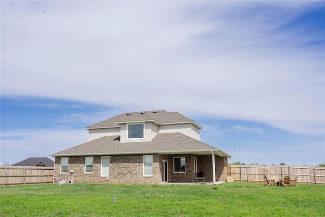 7310 S Brookwater Way, Stillwater, OK 74074 - exterior space with a shingled roof, brick siding, a front yard, and a fenced backyard