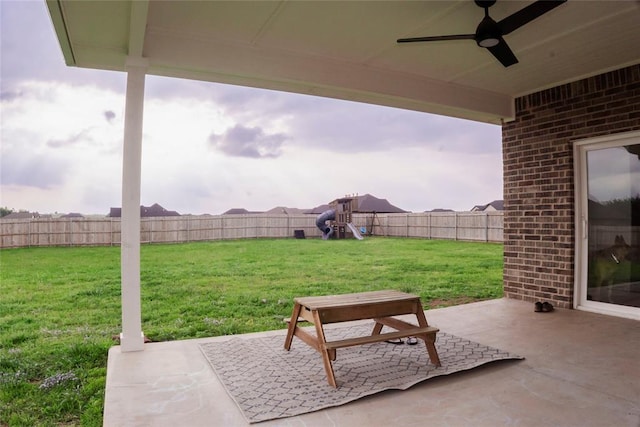 7310 S Brookwater Way, Stillwater, OK 74074 - view of patio / terrace featuring a fenced backyard, a playground, and a ceiling fan