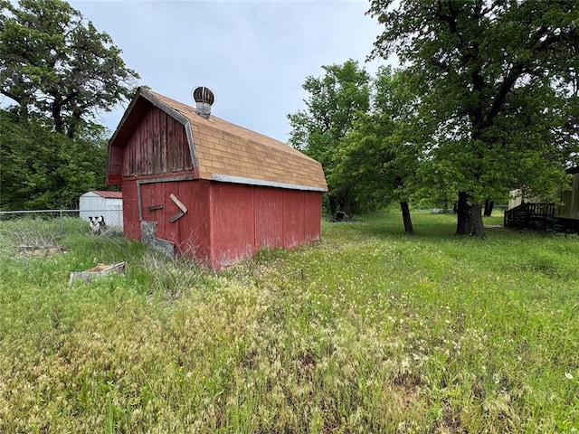 view of barn with fence