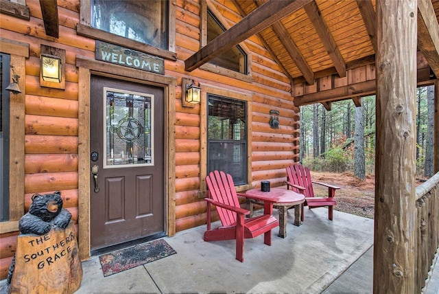 property entrance featuring log exterior