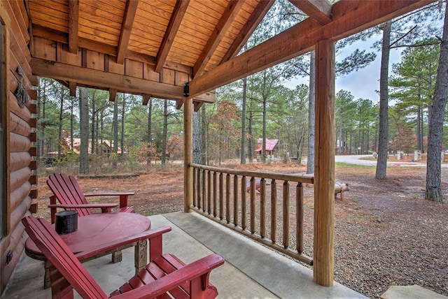 view of patio with covered porch and view of scattered trees