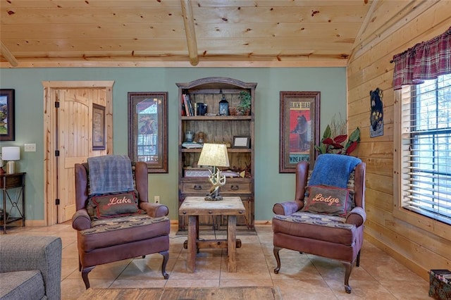 living area with wooden ceiling, wooden walls, tile patterned flooring, and baseboards